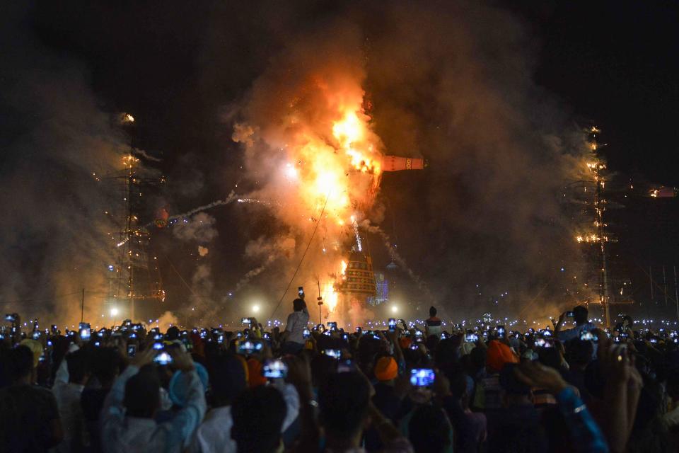 <p>Indian Hindu devotees watch an effigy of the Hindu demon king Ravana, stuffed with fire-crackers, burn in Amritsar on Sept. 30, 2017, on the occasion of the Hindu festival of Dussehra. Held at the end of the Navratri (nine nights) Festival, Dussehra symbolises the victory of good over evil in Hindu mythology. On the night of Dussehra, fire-crackers and stuffed effigies of Ravana are set alight in open grounds across the country. (Photo: Narinder Nanu/AFP/Getty Images) </p>