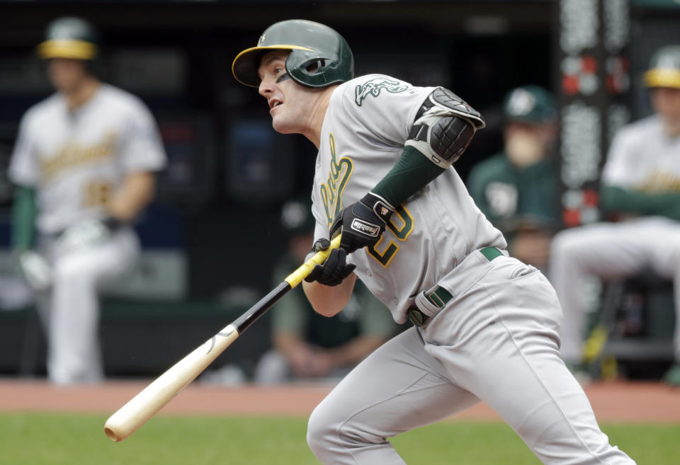 Oakland Athletics' Mark Canha watches his ball after hitting against Cleveland Indians starting pitcher Jefry Rodriguez in the first inning of a baseball game, Wednesday, May 22, 2019, in Cleveland. Canha grounded into a fielders choice. Marcus Semien scored on the play. (AP Photo/Tony Dejak)