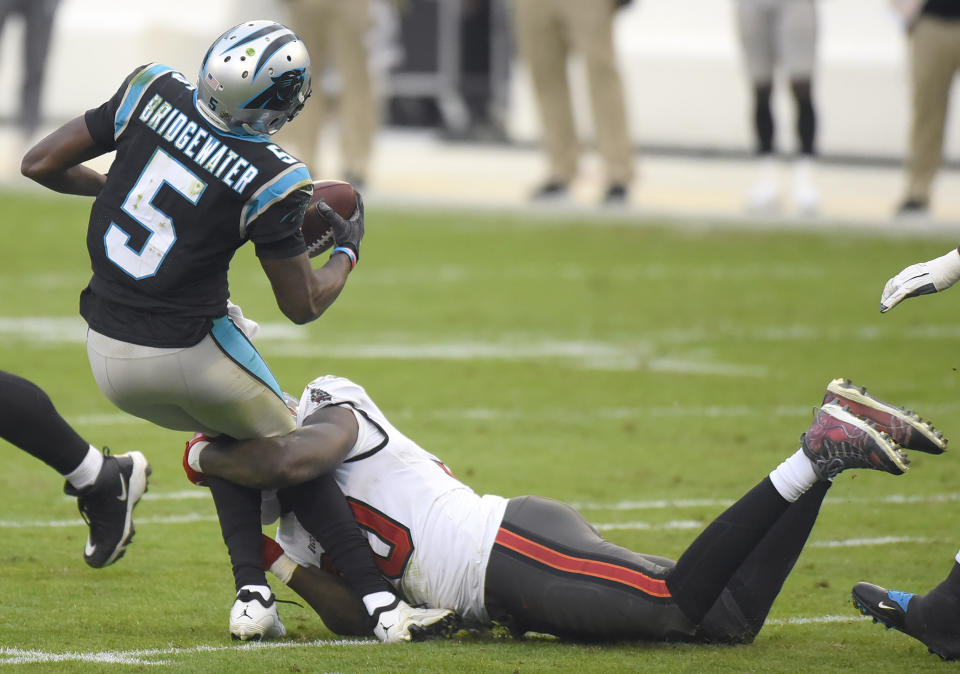 Carolina Panthers quarterback Teddy Bridgewater, left, is sacked by Tampa Bay Buccaneers outside linebacker Jason Pierre-Paul, right, during fourth-quarter NFL football game action in Charlotte, N.C., Sunday, Nov. 15, 2020. (Jeff Siner/The Charlotte Observer via AP)