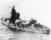 FILE - In this May 1942 file photo a Japanese heavy cruiser of the Mogami class lies low in the water after being bombed by U.S. naval aircraft during the Battle of Midway. Researchers scouring the world's oceans for sunken World War II ships are honing in on debris fields deep in the Pacific. A research vessel called the Petrel is launching underwater robots about halfway between the U.S. and Japan in search of warships from the Battle of Midway. (AP Photo, File)