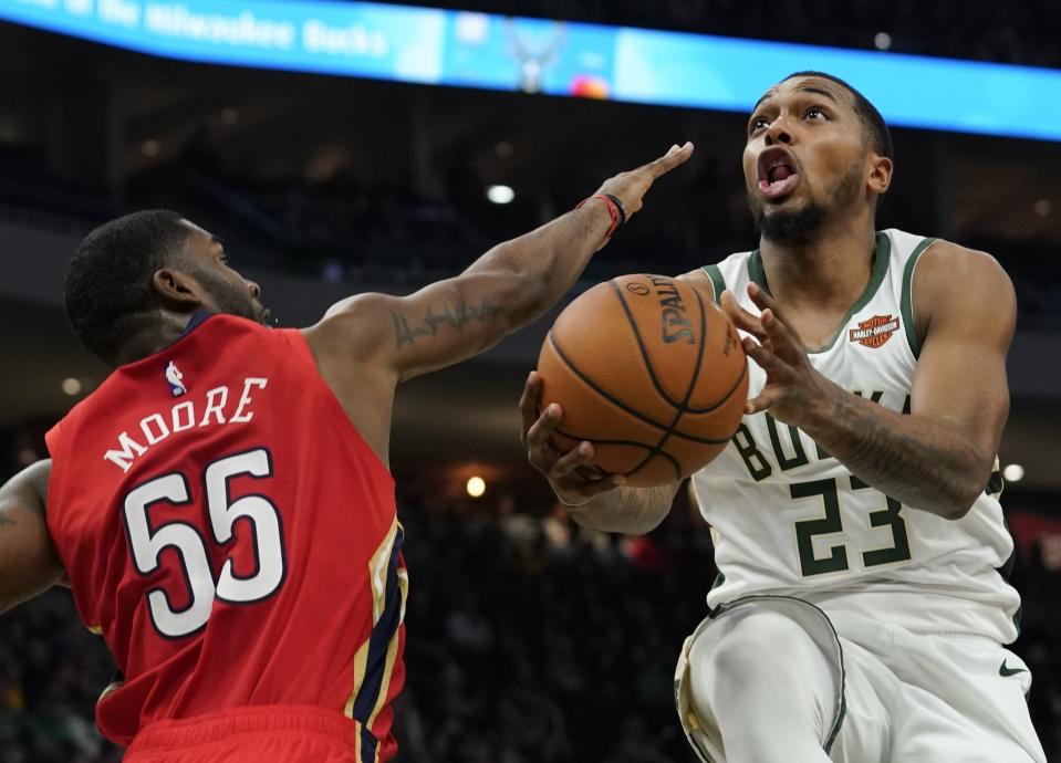 Milwaukee Bucks' Sterling Brown shoots past New Orleans Pelicans' E'Twaun Moore during the second half of an NBA basketball game Wednesday, Dec. 19, 2018, in Milwaukee. The Bucks won 123-115. (AP Photo/Morry Gash)