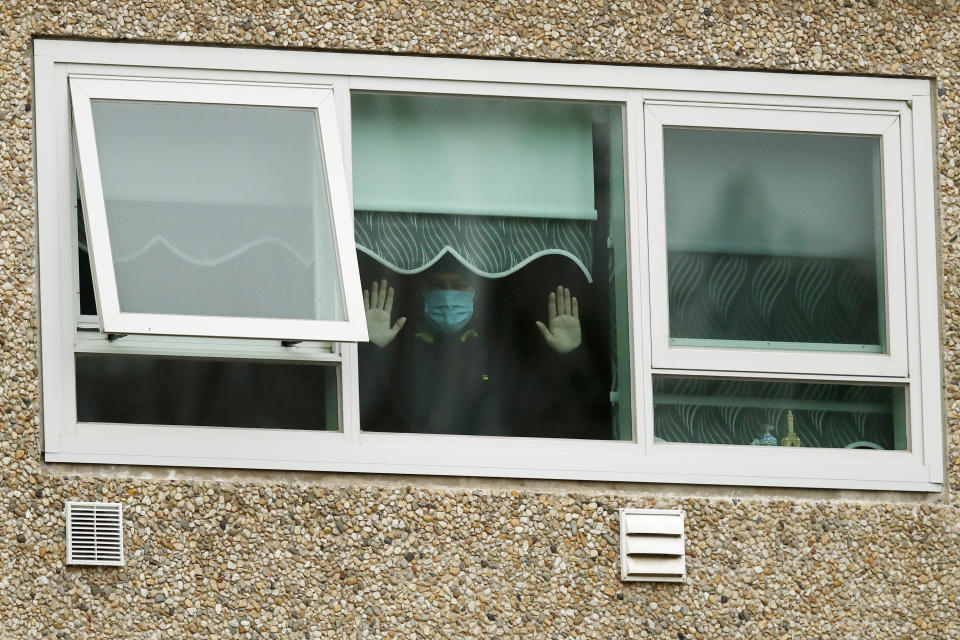 A man looking out a window of the locked-down housing complex on Monday in Melbourne.  (Photo: Darrian Traynor via Getty Images)