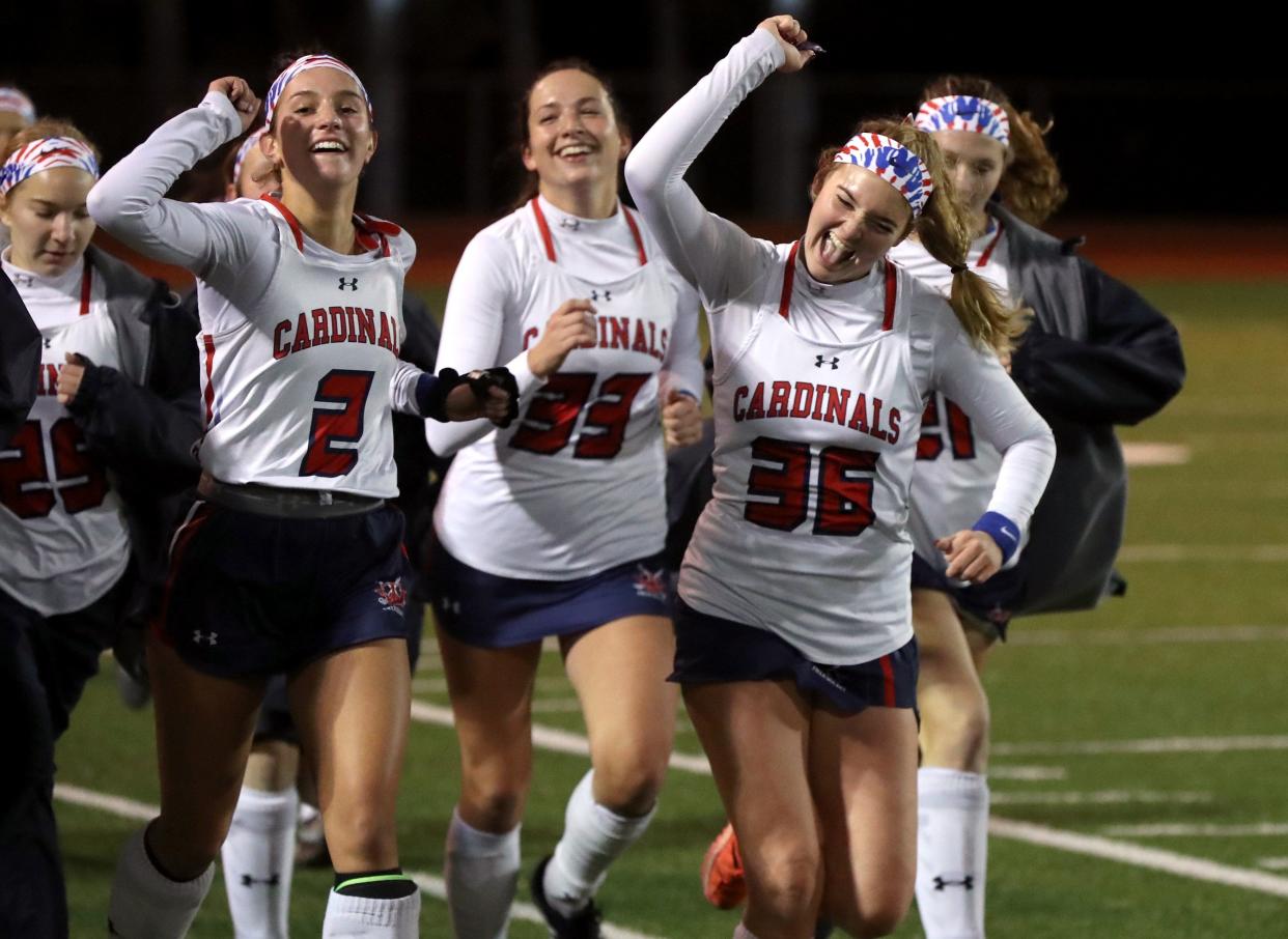 Thomas Worthington's Cora Hamilton (2) and Reilly Casey (36) gesture toward Cardinals fans as they take a lap around the field with teammates following a 1-0 win over Shaker Heights in an OHSAA Field Hockey State Semifinal game Nov. 4, 2021, at Thomas Worthington High School in Worthington, Ohio.