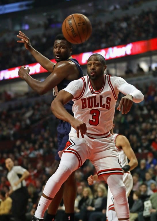 Dwyane Wade of the Chicago Bulls and Buddy Hield of the New Orleans Pelicans lose the ball during their NBA game, at the United Center in Chicago, Illinois, on January 14, 2017