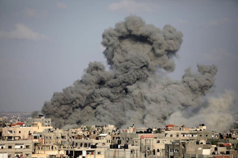Smoke rises above buildings, in the southern Gaza Strip, following an Israeli strike. Photo by Ismael Mohamad/UPI