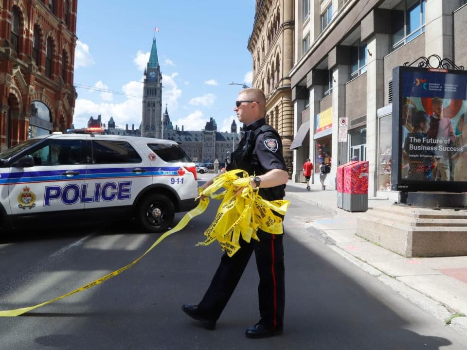 Police remove police tape after responding to an incident on Parliament Hill in Ottawa on Saturday, June 11, 2022.  (Patrick Doyle/The Canadian Press - image credit)