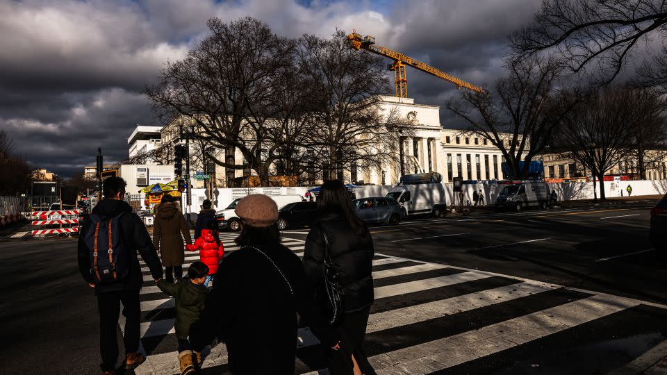 Pedestrians walk near the Marriner S. Eccles Federal Reserve building in Washington, DC, US, on Thursday, Dec. 28, 2023. - Valerie Plesch/Bloomberg/Getty Images