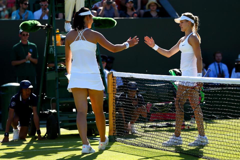 Ying-Ying Duan (L) of China celebrates winning her Ladies Singles first round match against Eugenie Bouchard.  (Photo by Clive Brunskill/Getty Images)