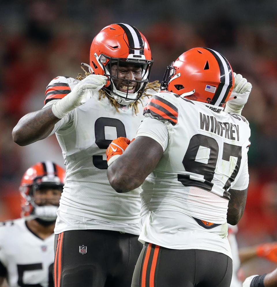 Cleveland Browns defensive end Alex Wright, facing, celebrates with Cleveland Browns defensive tackle Perrion Winfrey (97) after Winfrey recovered a Chicago Bears fumble during the first half of an NFL preseason football game, Saturday, Aug. 27, 2022, in Cleveland, Ohio.
