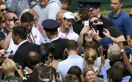 Britain Tennis - Wimbledon - All England Lawn Tennis & Croquet Club, Wimbledon, England - 9/7/16 Great Britain's Andy Murray poses for a selfie with fans after a practice session REUTERS/Toby Melville