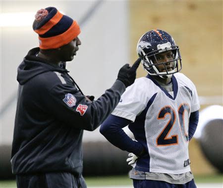 Denver Broncos assistant secondary coach Sam Garnes works with free safety Mike Adams during their practice session for the Super Bowl at the New York Jets Training Center in Florham Park, New Jersey January 30, 2014. REUTERS/Ray Stubblebine