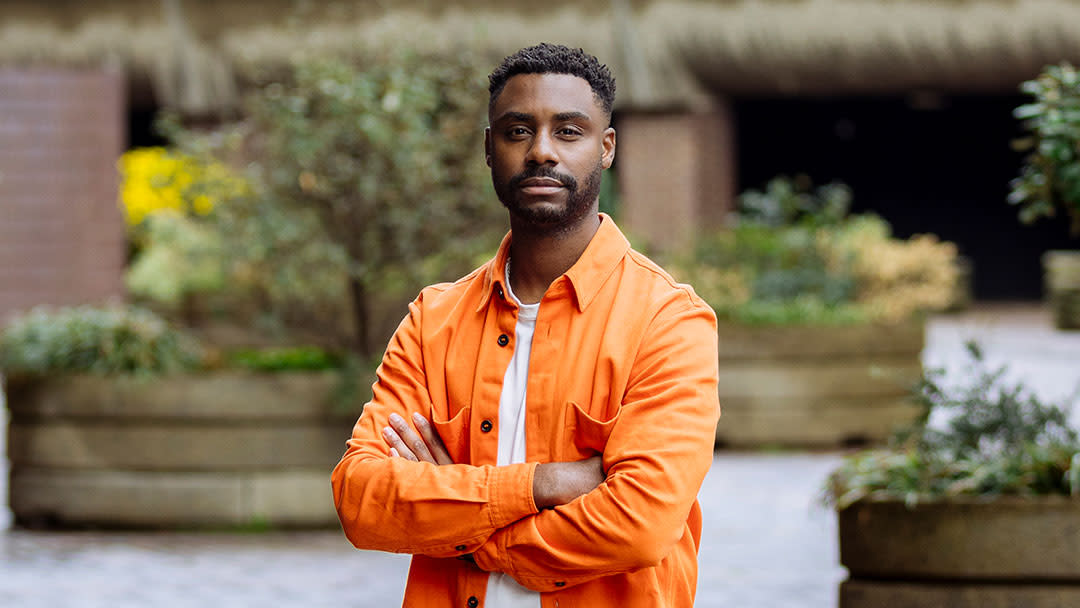  Kieron Lewis headshot - man in an orange shirt. 