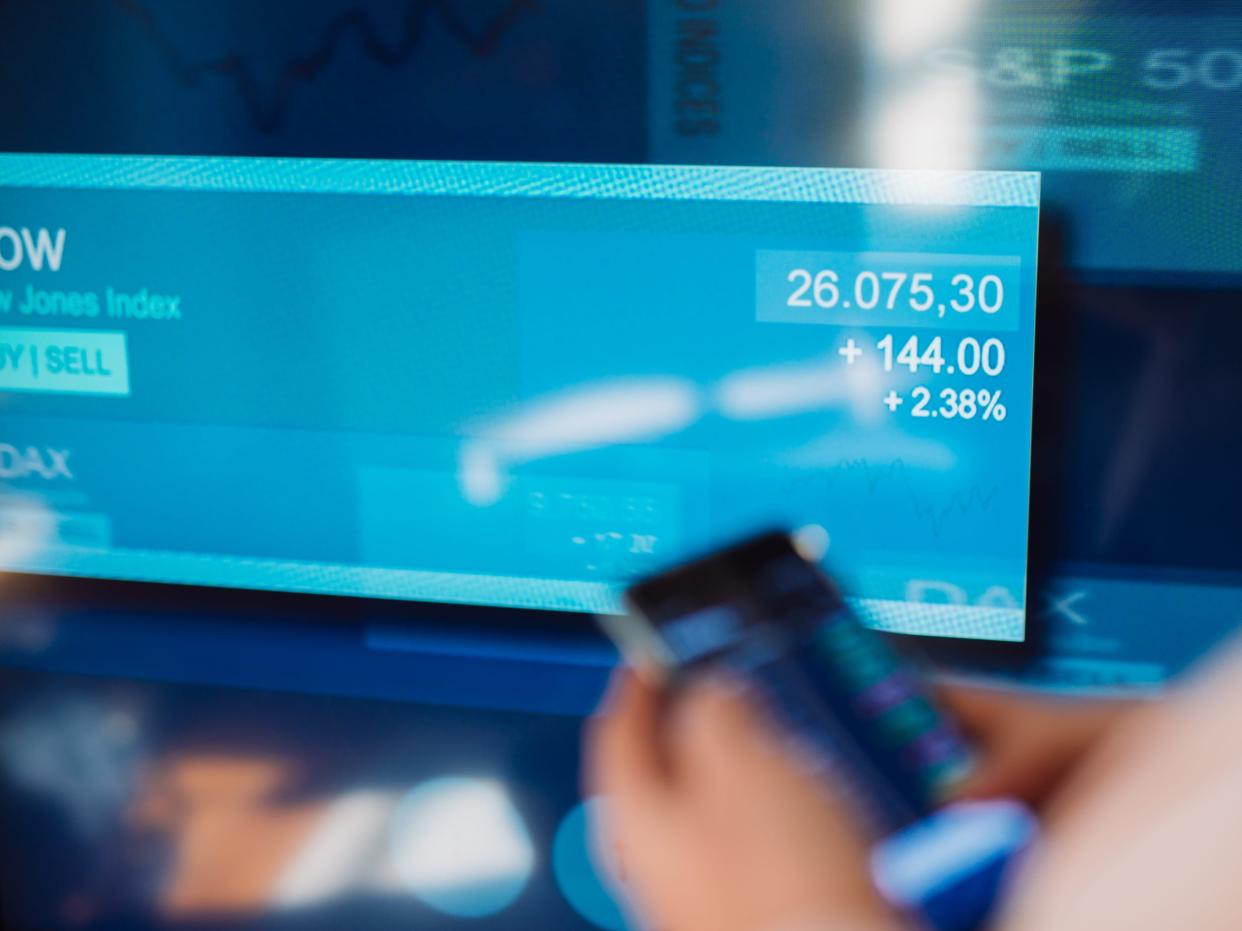 Woman trading stocks on phone