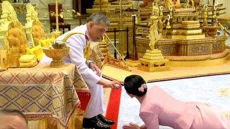 King Maha Vajiralongkorn and his consort, General Suthida Vajiralongkorn named Queen Suthida, attend their wedding ceremony in Bangkok, Thailand May 1, 2019, in this screen grab taken from a video. Thai TV Pool