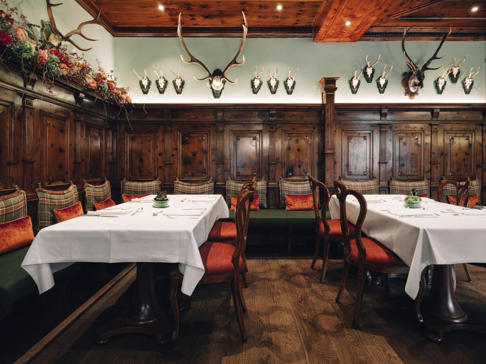 The Sacher Zirbelzimmer restaurant sits in an original wood-panelled room adorned with hunting trophies (Hotel Sacher Salzburg)