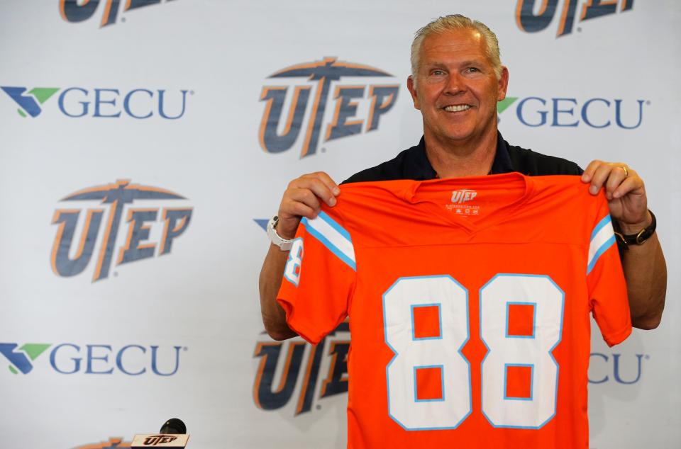 UTEP head coach Dana Dimel holds one up of the jerseys honoring the Miners' 1988 team that were given away to the first 1,000 fans during the 2018 homecoming game in the Sun Bowl.