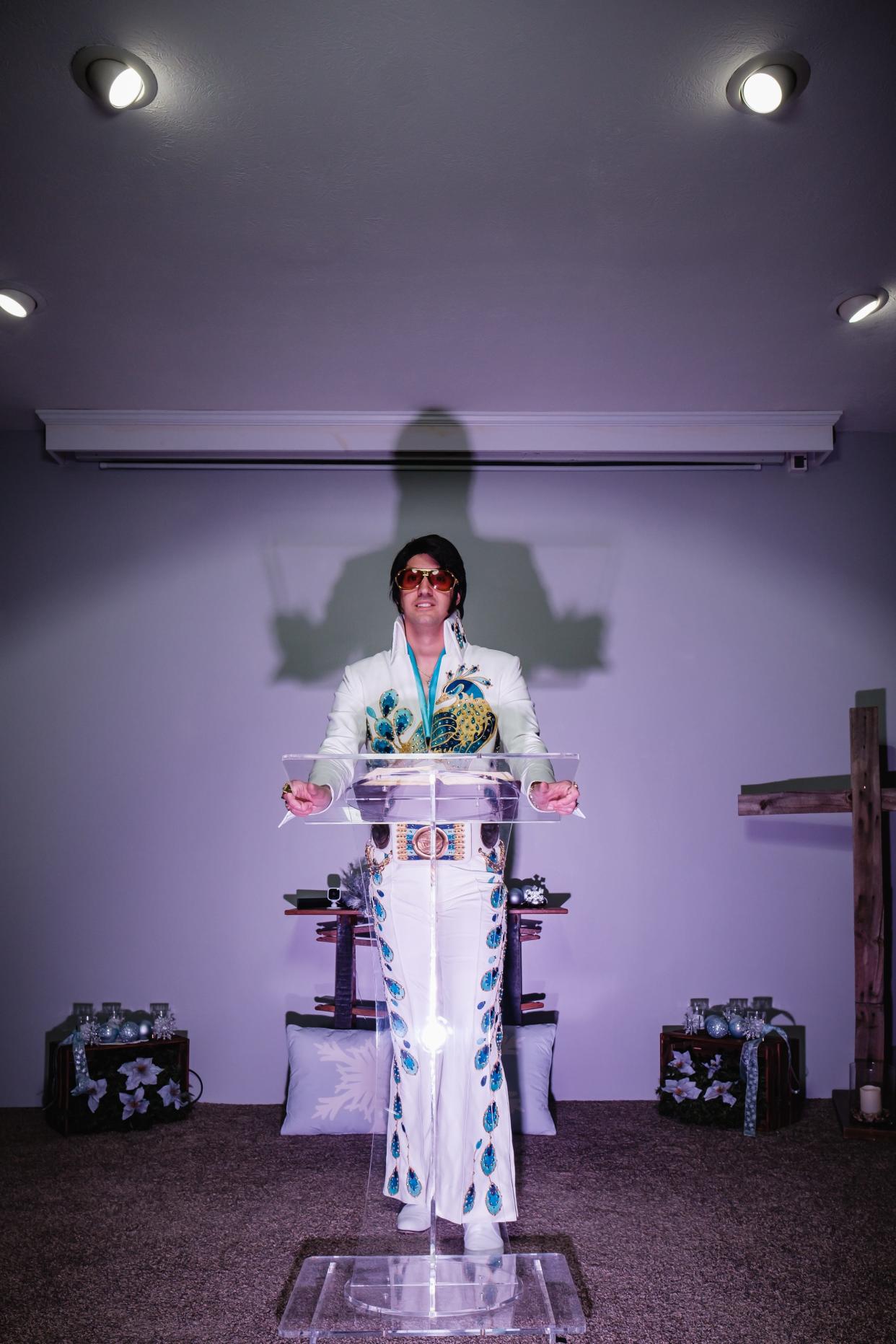 Michael Brindley, pastor of Organic Church in Uhrichsville, poses in an exact replica of the peacock jumpsuit worn by Elvis Presley. He puts on Elvis shows, and from time to time interjects faith teachings into those shows.