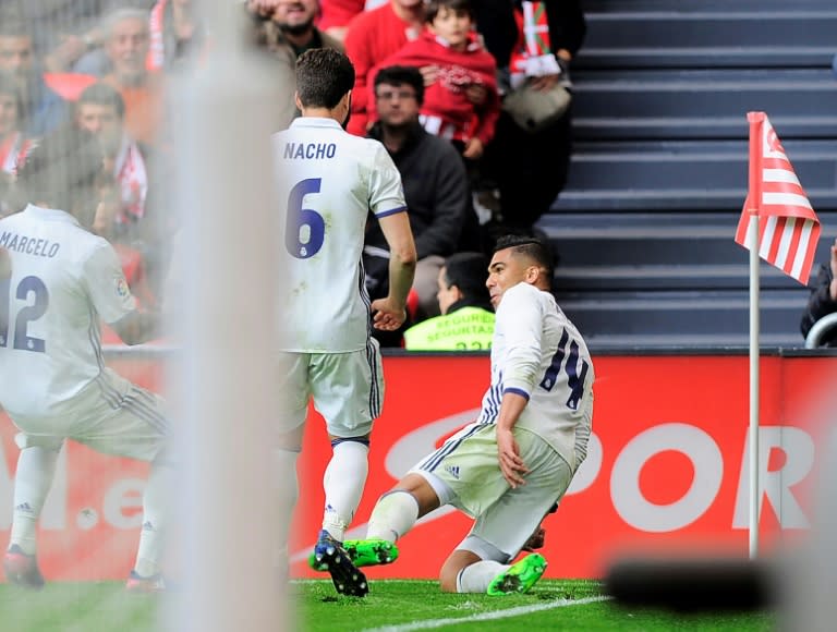 Real Madrid's midfielder Carlos Henrique Casemiro (R) celebrates after scoring his team's second goal during the Spanish league football match against Athletic Club Bilbao at the San Mames stadium in Bilbao on March 18, 2017