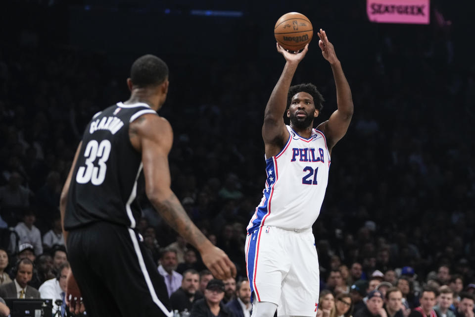 Philadelphia 76ers' Joel Embiid (21) shoots over Brooklyn Nets' Nic Claxton (33) during the first half of Game 3 in an NBA basketball first-round playoff series Thursday, April 20, 2023, in New York. (AP Photo/Frank Franklin II)