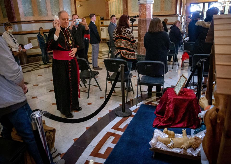 Bishop Thomas John Paprocki blesses the Nativity scene on display in the rotunda of the state Capitol during a ceremony hosted by the Springfield Nativity Scene Committee on Tuesday. [Justin L. Fowler/The State Journal-Register]