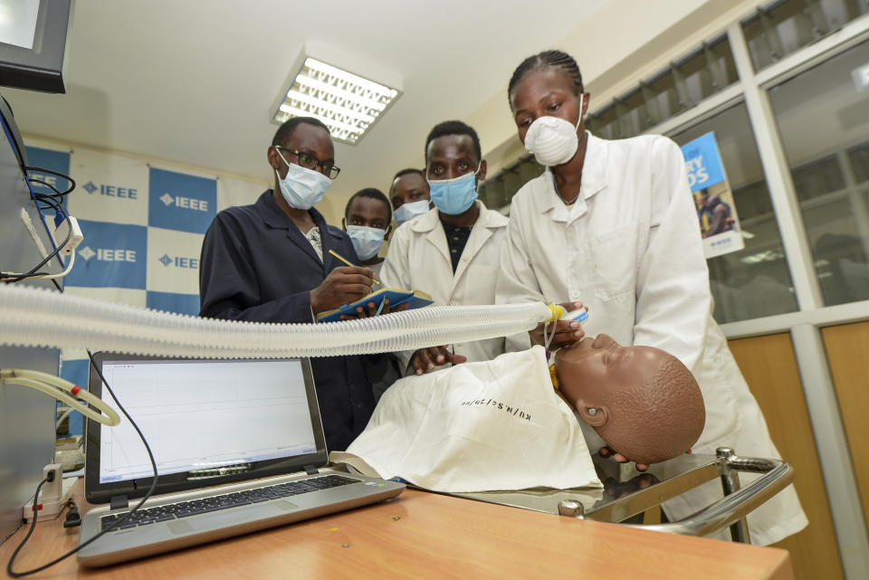 In this photo taken Monday, April 13, 2020, medical students test a self-designed computer-controlled ventilator prototype at the Chandaria Business and Incubation Centre of Kenyatta University in Nairobi, Kenya. Researchers across Africa are looking for ways to make their own ventilators, protective equipment and hand sanitizers as the continent faces a peak in coronavirus cases long after the United States and European countries have bought up global supplies during the pandemic. (AP Photo/John Muchucha)