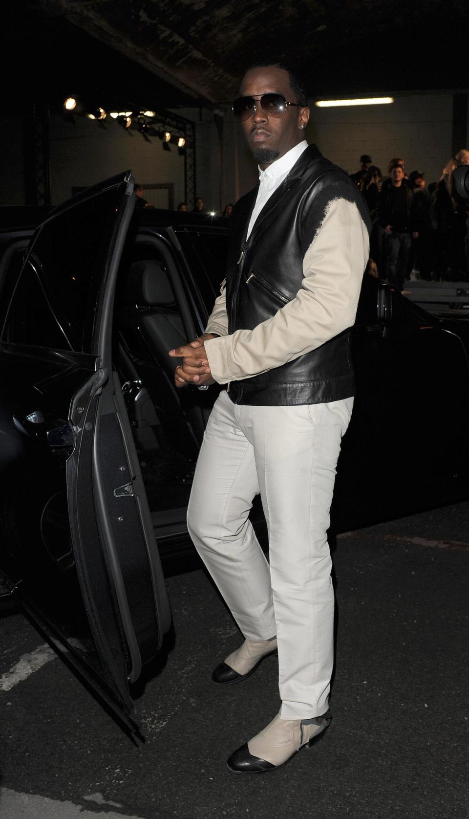 Sean Combs and Kim Kardashian attend the Kanye West runway show at Paris Fashion Week AW 2012