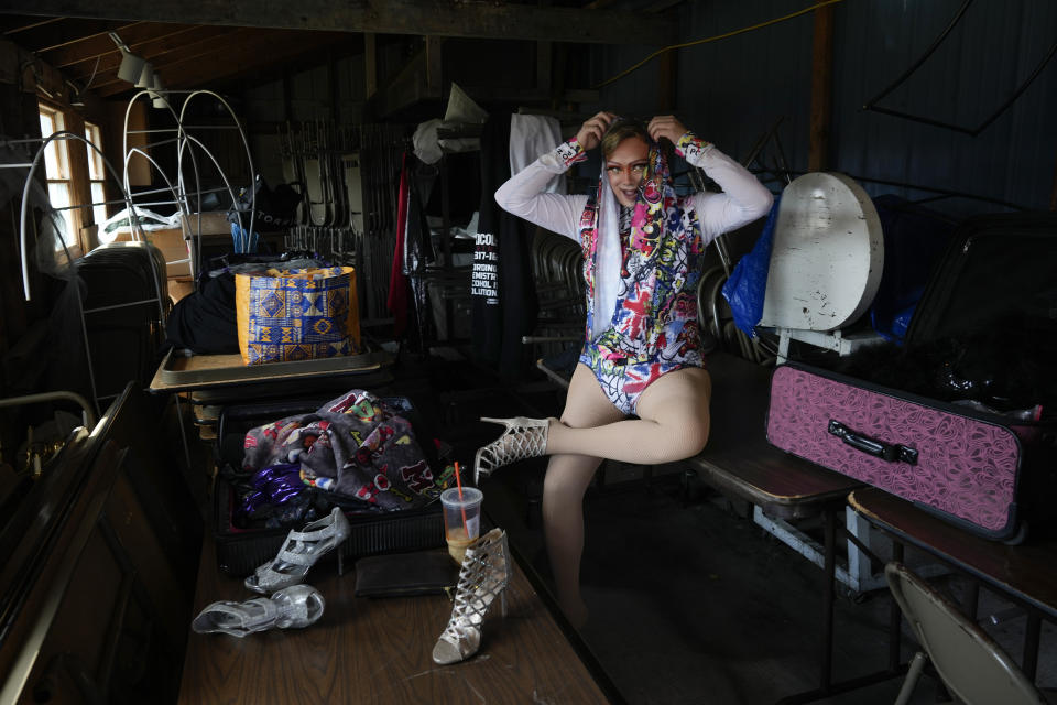 Drag queen Trixy Valentine, aka Jacob Kelley, dresses in a side storage room during the sold-out "Drag Bingo" fundraiser at the Nescopeck Township Volunteer Fire Company Social Hall, in Nescopeck, Pa., Saturday, March 18, 2023, to raise money for a new roof for the Berwick Theater and Center for Community Arts, in Berwick, Pa. (AP Photo/Carolyn Kaster)