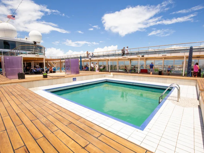 A pool on the pool deck. There's no one inside.