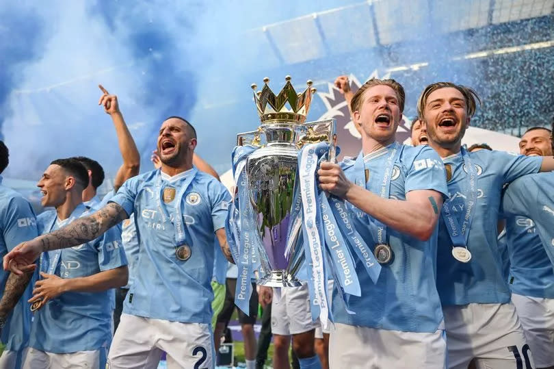 Manchester City players celebrate winning the Premier League