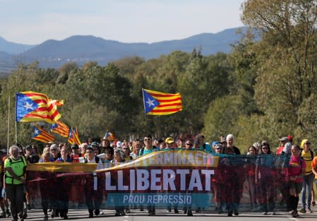 Separatist demonstrators march during a protest after a verdict in a trial over a banned Catalonia's independence referendum near Sils