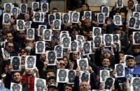 Football Soccer - Napoli v Carpi - Serie A - San Paolo Stadium, Naples, Italy - 07/02/16. Napoli's supporters hold a picture of Napoli's player Kalidou Koulibaly before the match. REUTERS/Stringer