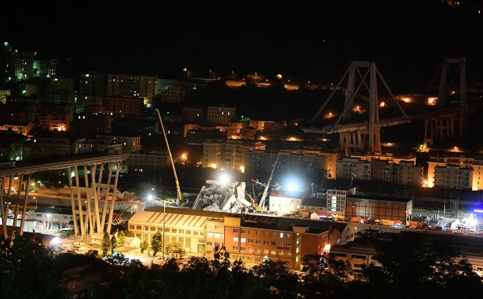 A night view of the collapsed Morandi bridge in Genoa, Italy, Wednesday, Aug. 15, 2018. A highway bridge collapsed Monday killing at least 39 people. (Luca Zennaro/ANSA via AP)