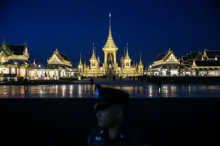 A police officer stands guard in front of the Royal Crematorium site before a funeral rehearsal for late Thailand's King Bhumibol Adulyadej near the Grand Palace in Bangkok, Thailand October 21, 2017. REUTERS/Athit Perawongmetha