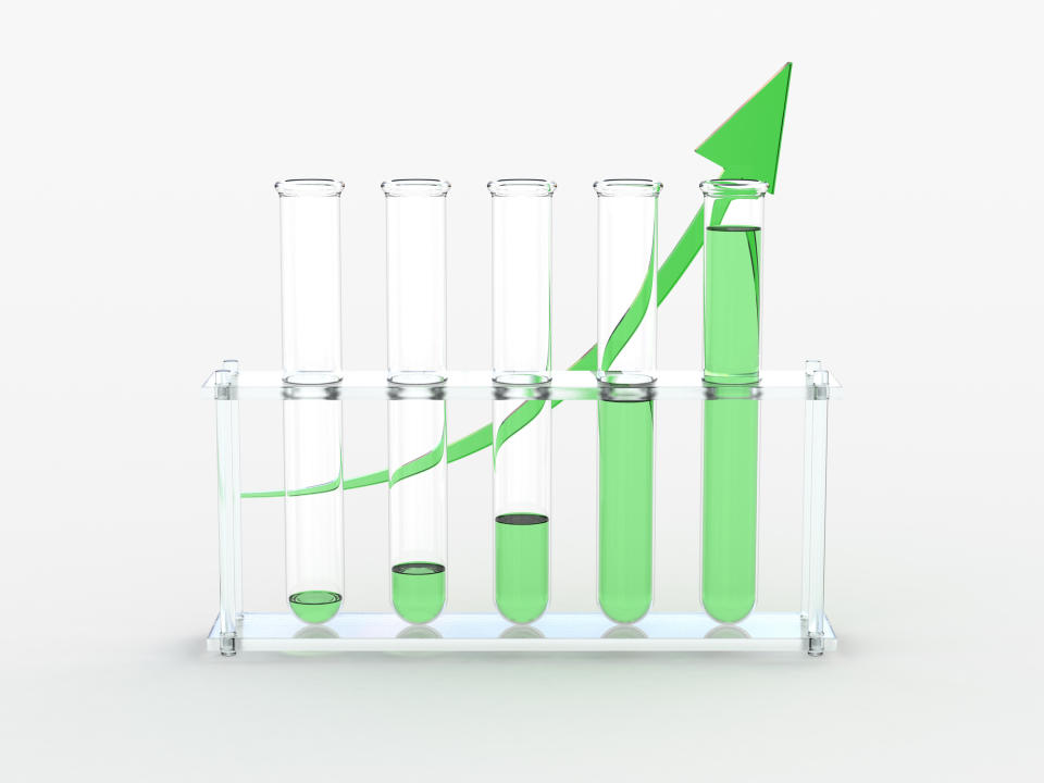 Five test tubes with increasingly higher levels of green fluid in each tube and a green line with an arrow at the end curving upward behind the test tubes