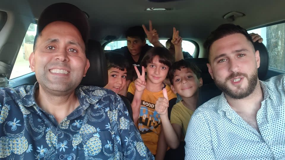 A photo from happier times. Writer Hani Almadhoun (left) on a road to trip to Beit Lahia beach, with his nieces and nephews in the back of the car, during a visit to Gaza over summer this year. - Hani Almadhoun