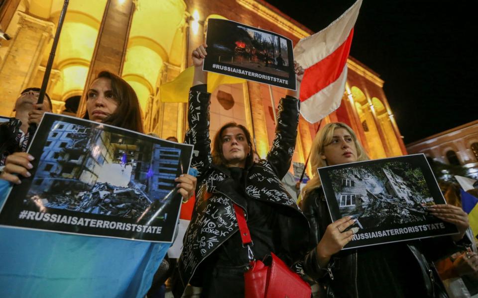 Protesters hold a rally to condemn recent Russian widespread missile strikes on Ukraine, in Tbilisi, Georgia - Reuters