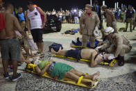 <p>Firefighters give the first aid to people that were hurt after a car drove into the crowded seaside boardwalk along Copacabana beach in Rio de Janeiro, Brazil, Thursday, Jan. 18, 2018. (Photo: Silvia Izquierdo/AP) </p>