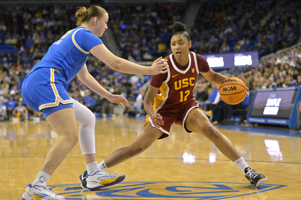 Dec 30, 2023; Los Angeles, California, USA; USC Trojans guard JuJu Watkins (12) is defended by UCLA Bruins forward Lina Sontag (21) in the second half at Pauley Pavilion presented by Wescom. Jayne Kamin-Oncea-USA TODAY Sports