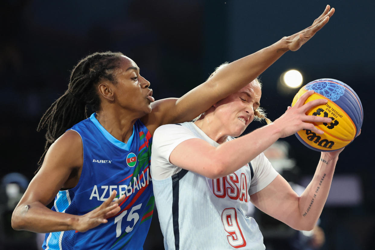 Azerbaijan's #15 Tiffany Hayes (L) tries to block US' #09 Hailey van Lith in the women's pool round 3x3 basketball game between the USA and Azerbaijan during the Paris 2024 Olympic Games at La Concorde in Paris on July 31, 2024. (Photo by David GRAY / AFP) (Photo by DAVID GRAY/AFP via Getty Images)