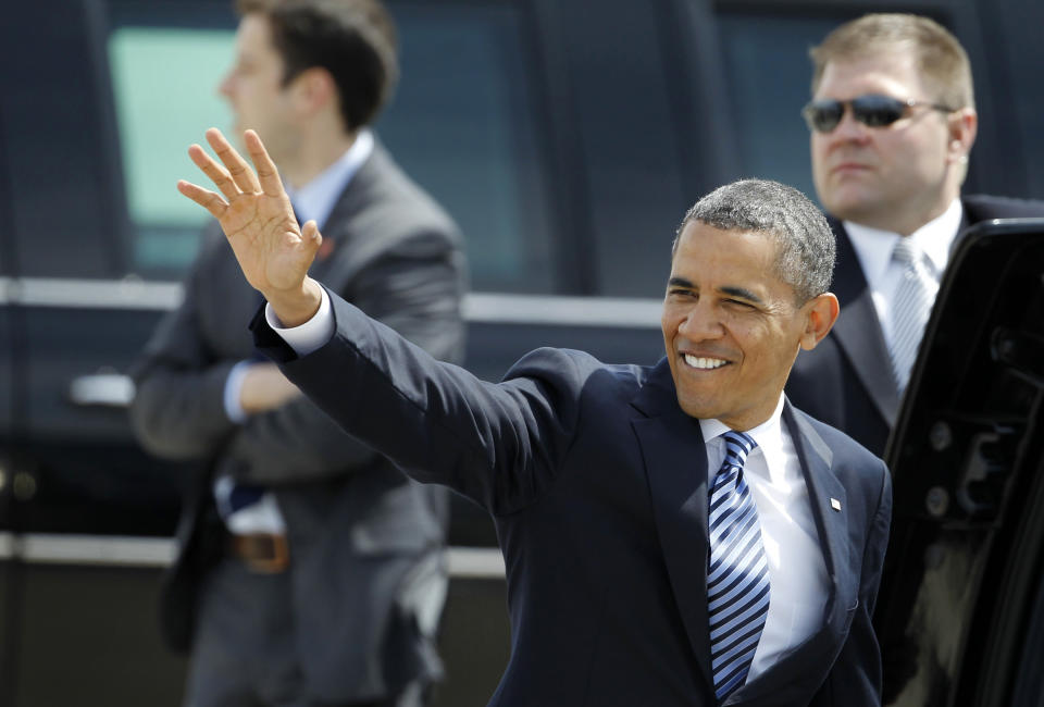 President Barack Obama waves before getting into the presidential limousine after greeting people at Eastern Iowa Airport in Cedar Rapids, Iowa, Wednesday, April 25, 2012. (AP Photo/Matthew Putney)