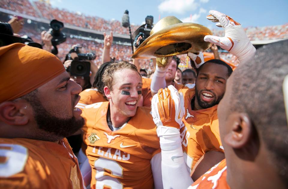 Texas Longhorns'(6) Case McCoy celebrates with (44) Jackson Jeffcoat after beatimg Oklahoma Sooners 36-20 in the AT&T Red River Rivalry of an NCAA college football game at Cotton Bowl Stadium in Dallas,TX., Saturday, Oct. 12, 2013.