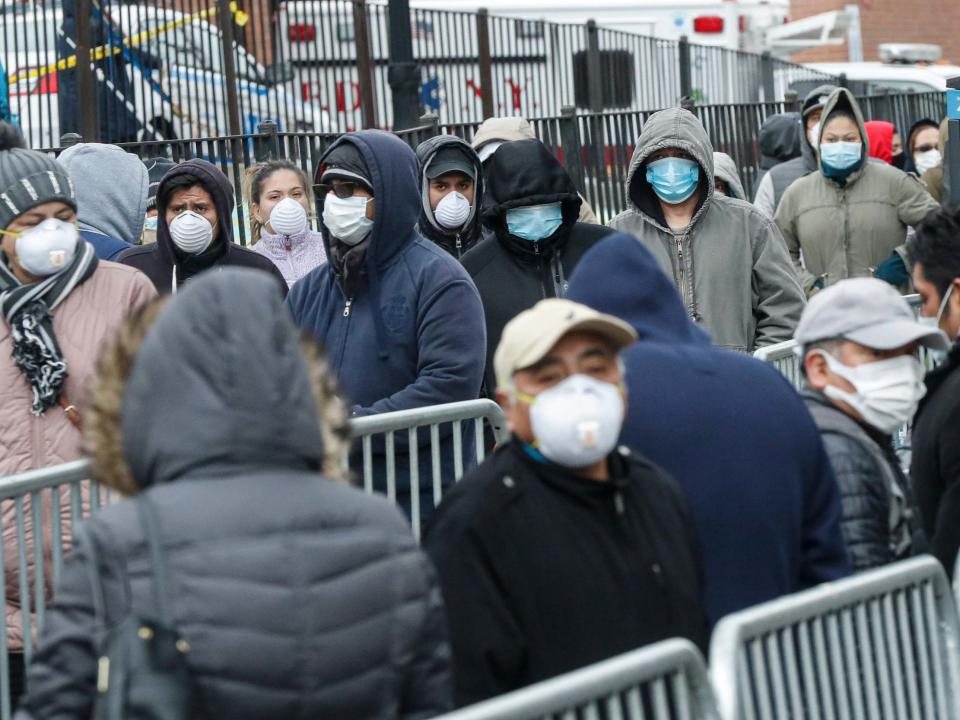 New Yorkers in the borough of Queens queue at Elmhurst hospital for coronavirus tests, as 13 deaths are reported in one day: AP
