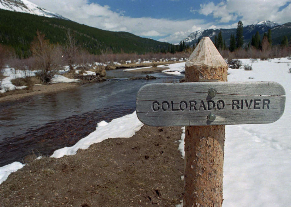 FILE - In this Thursday, May 1, 1997, file photograph, a sign marks the Colorado River as it flows past the Never Summer Mountains in Rocky Mountain National Park near the town of Grand Lake, Colo. The U.S. Department of Energy on Tuesday, Aug. 24, 2021, announced a new kind of climate observatory near the headwaters of the Colorado River that will help scientists better predict rain and snowfall in the U.S. West and determine how much of it will flow through the region. (AP Photo/David Zalubowski, File)