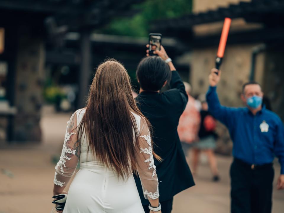 Freelancer Mystee Yannarella in front of bachelors with lightsabers.