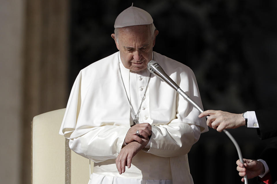 Pope Francis checks his watch as he arrives for the weekly general audience in St.Peter's Square at the Vatican, Wednesday, Nov. 7, 2018. (AP Photo/Gregorio Borgia)