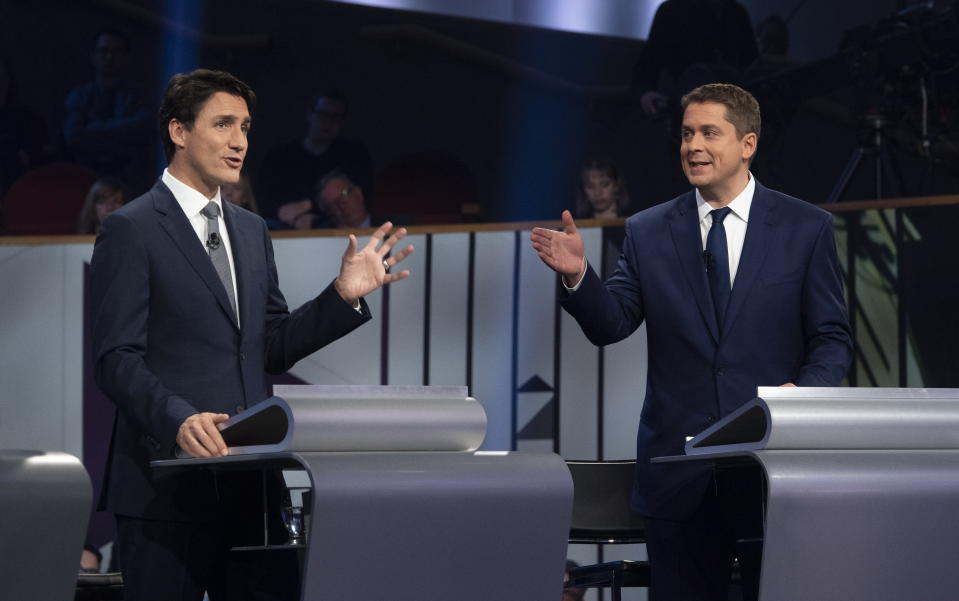 FILE - In this Oct. 10, 2019, file photo, Liberal leader Justin Trudeau and Conservative leader Andrew Scheer take part in the Federal leaders French language debate in Gatineau, Quebec. Polls show that Scheer has a chance to defeat Trudeau's Liberal party in national elections on Monday, Oct. 21. (Adrian Wyld/The Canadian Press via AP)