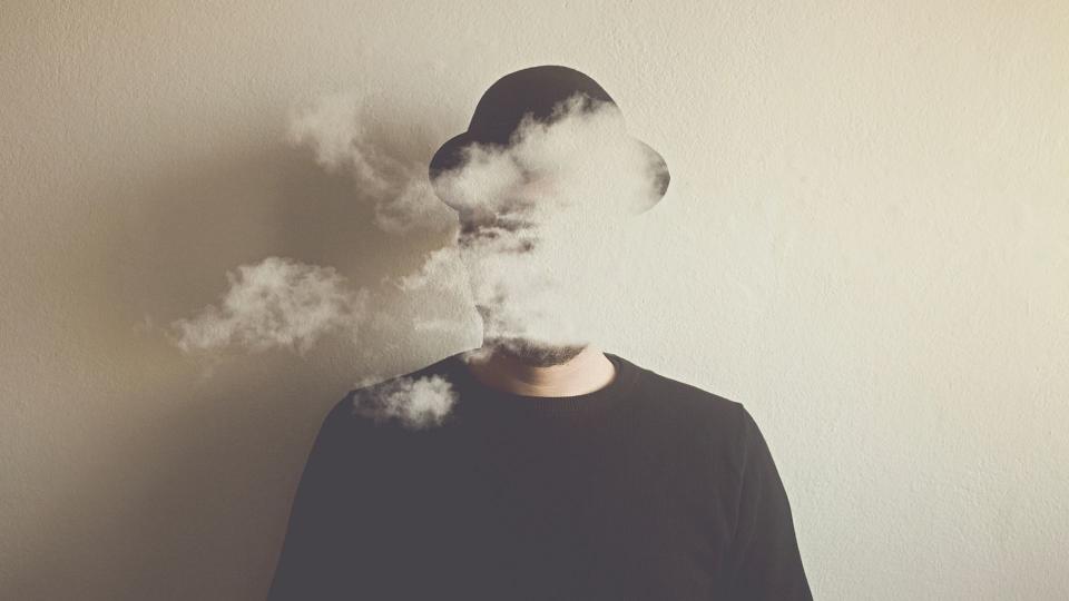 Abstract image of man wearing bowler hat with cloud for head. 