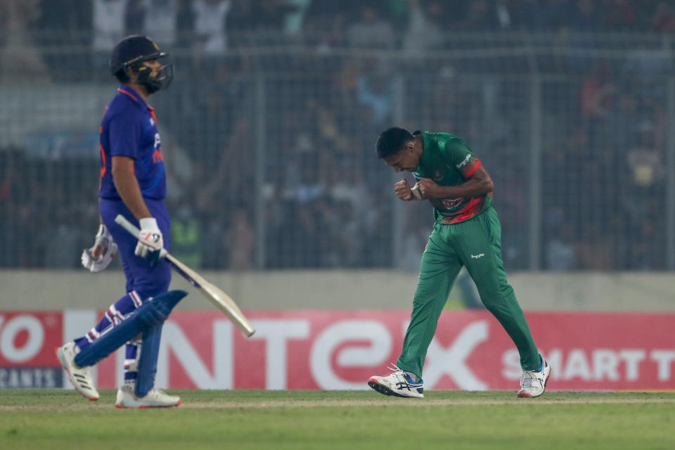 Indian captain Rohit Sharma, left, walks back as Bangladesh' Mustafizur Rahman right celebrates winning the second one day international cricket match between Bangladesh and India in Dhaka, Bangladesh, Wednesday, Dec. 7, 2022. (AP Photo/Surjeet Yadav)