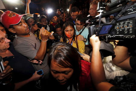 Two female relatives (C) of Filipino death row prisoner Mary Jane Veloso are escorted at Wijayapura port after returning from the prison island of Nusakambangan in Cilacap, Central Java province, Indonesia, April 29, 2015. REUTERS/Beawiharta