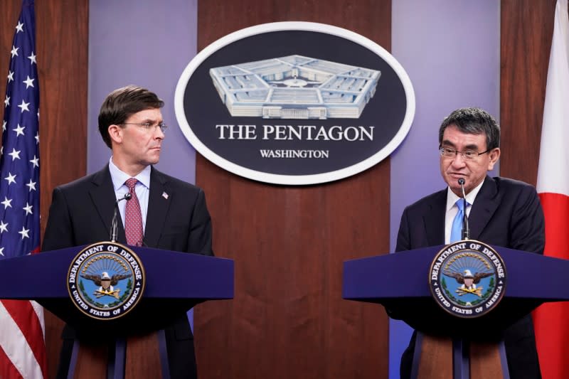 U.S. Secretary of Defense Mark Esper looks on as Japan's Defense Minister Taro Kono speaks during a joint news conference at the Pentagon in Washington